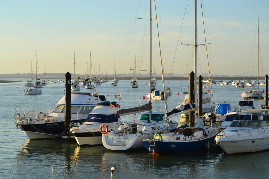 pexels-photo-30188958-30188958 A tranquil summer scene of moored boats in a harbor, with clear skies and calm waters.